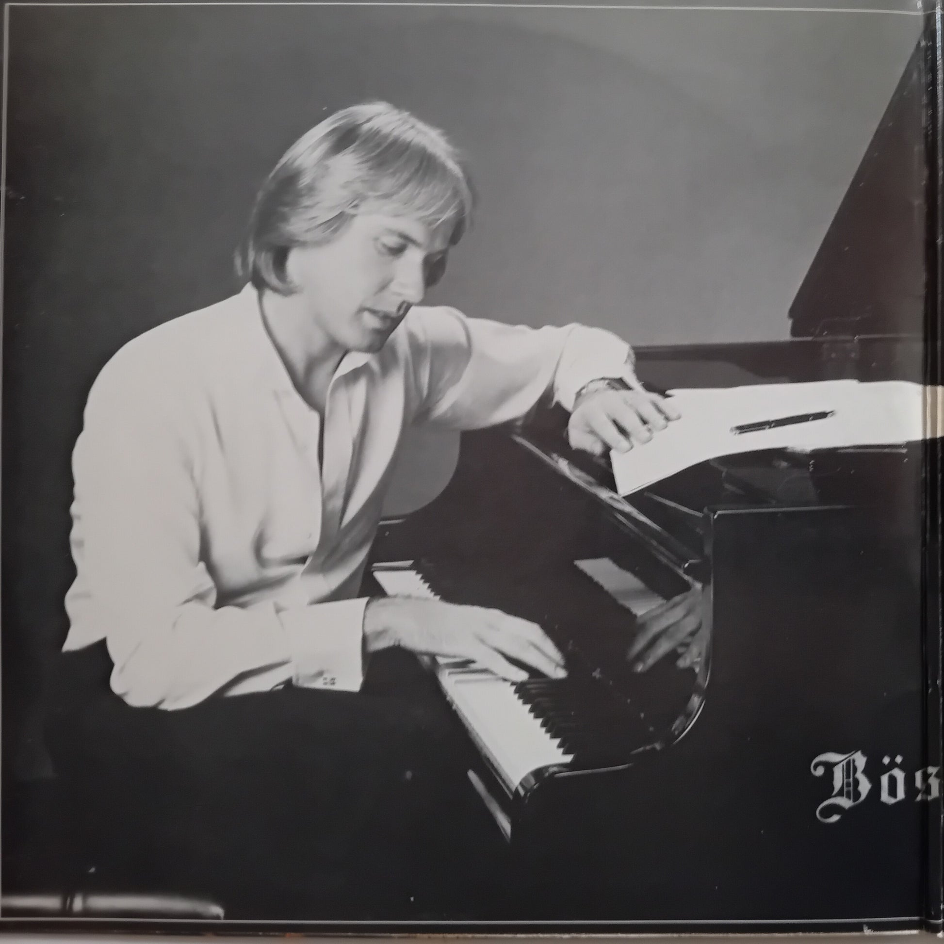 Black and white album cover featuring a man playing a grand piano, with the text 'Bös' visible in the lower right corner.