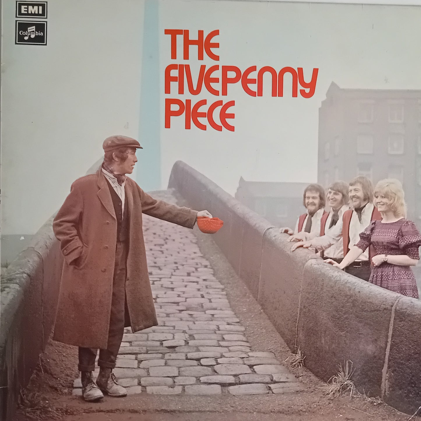 Album cover for 'The Five Penny Piece' on EMI Records, featuring a man in a brown coat standing on a cobblestone bridge and holding a red bowl, with four women leaning on the bridge railing in the background. The title is printed in large red letters at the top right.
