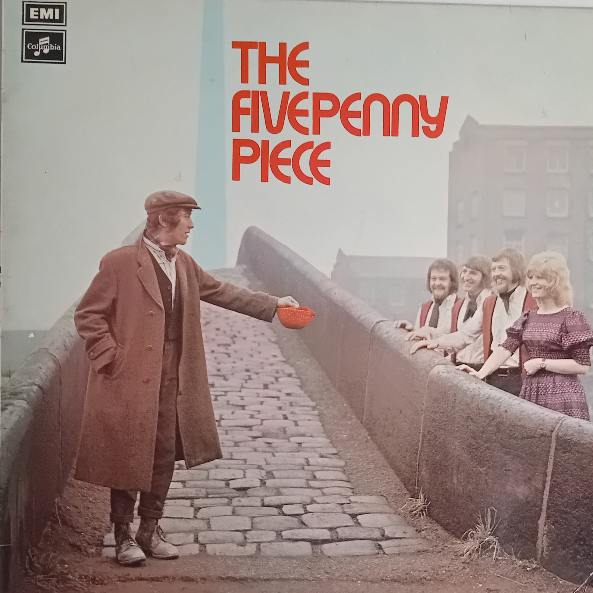 Album cover for 'The Five Penny Piece' on EMI Records, featuring a man in a brown coat standing on a cobblestone bridge and holding a red bowl, with four women leaning on the bridge railing in the background. The title is printed in large red letters at the top right.