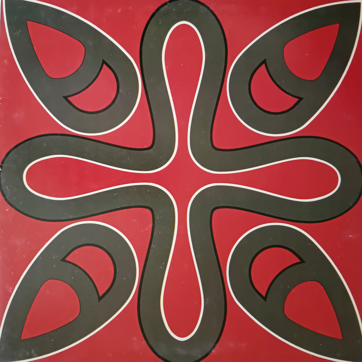 A square abstract artwork featuring a symmetrical six-petal floral or paisley-like motif in dark charcoal gray with white outlines on a solid red background.