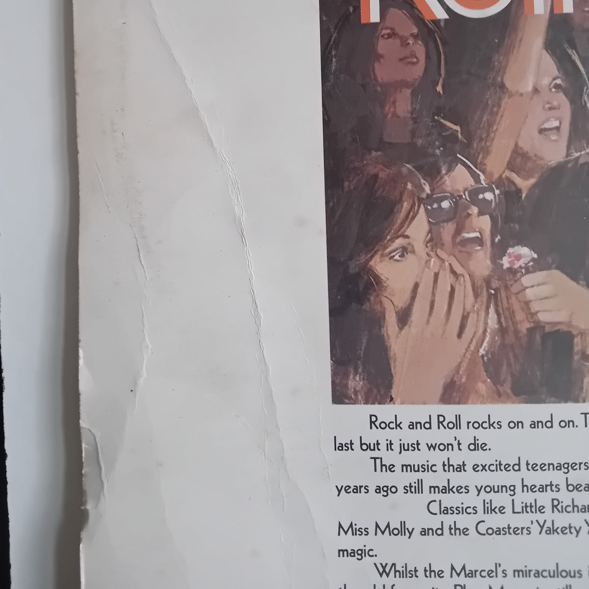 A close-up of an LP cover showing a vintage-style illustration of young women in a theatre or concert setting, with partial headline text at the top and paragraphs of text below on a white page.