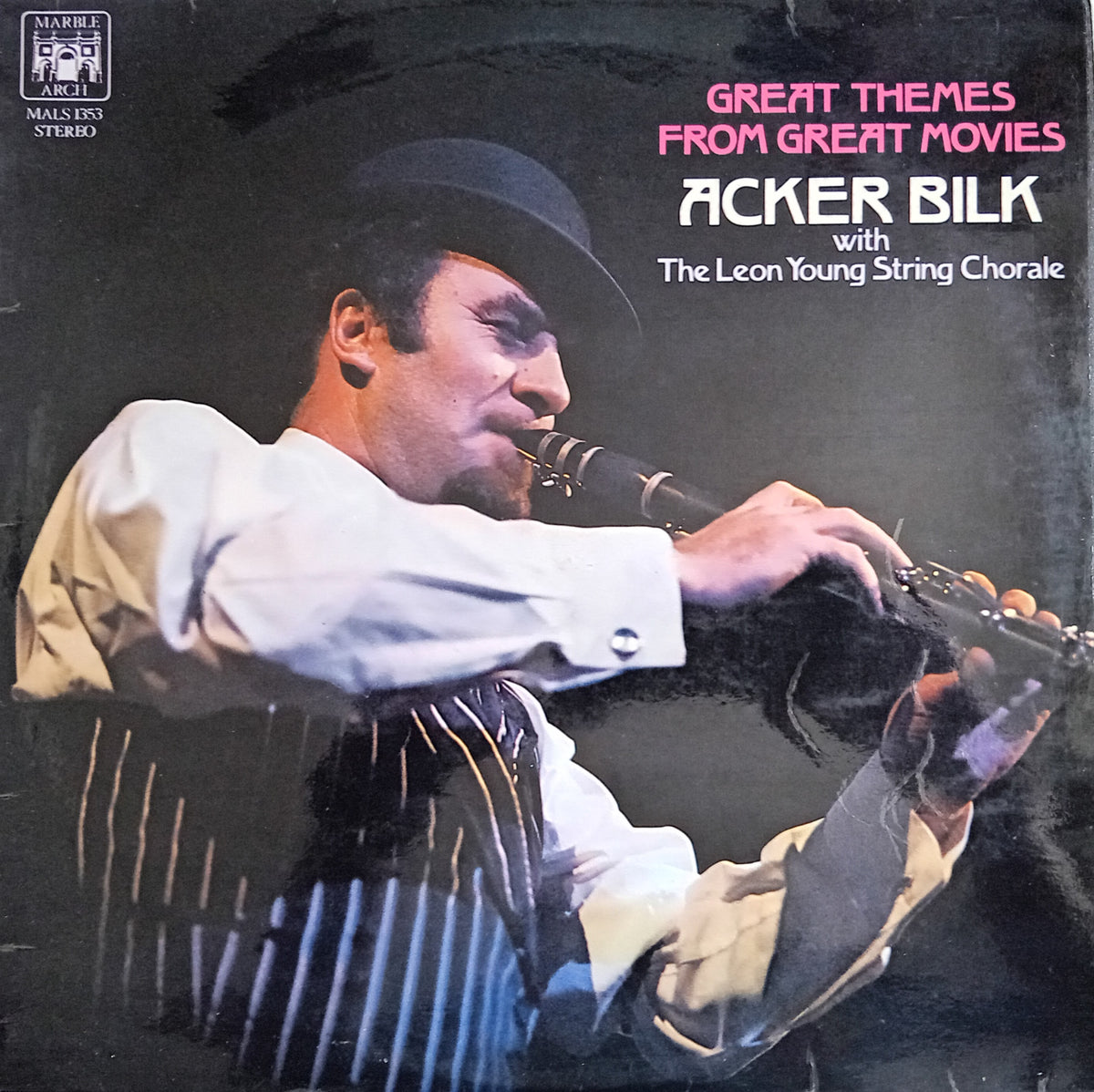 A square album cover for 'Great Themes from Great Movies' featuring Acker Bilk with The Leon Young String Chorale. The cover shows a dramatic photo of Acker Bilk in a black hat and white shirt playing a clarinet, with pink and white text on a dark background.