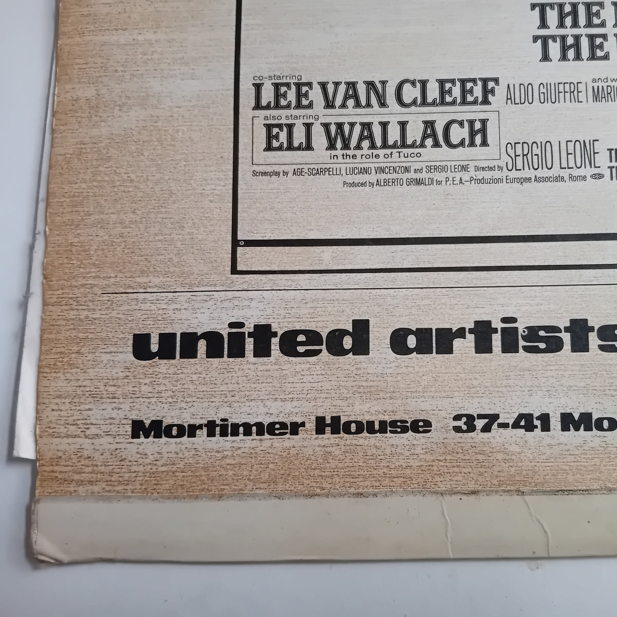A close-up of a vintage printed LP cover with black text on a beige paper background, including the names Lee Van Cleef and Eli Wallach and the text 'United Artists' and 'Mortimer House 37-41 Mo.