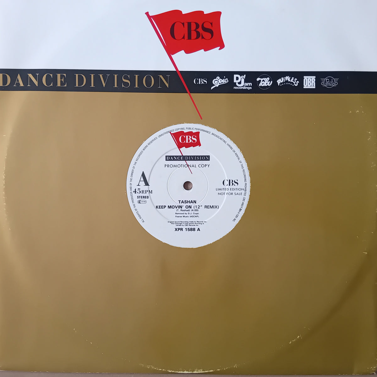 A vinyl record sleeve for CBS Records' 'Tashan - Keep Movin' On (12" Remix)' featuring a gold-coloured background, a white centre label, and a red CBS flag graphic at the top.