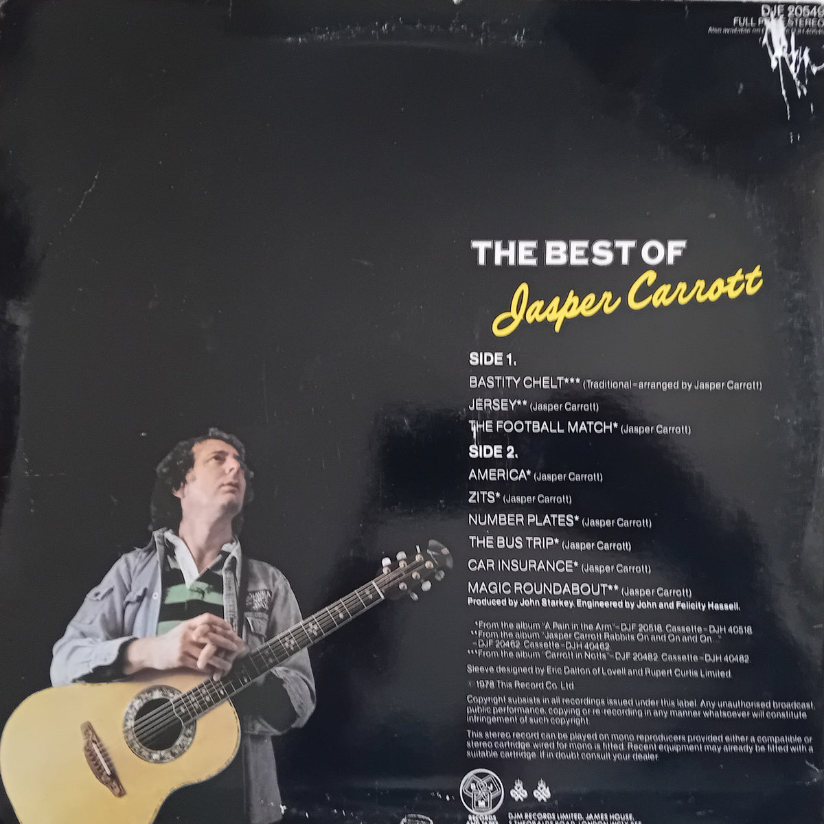 Back cover of a vinyl record for 'The Best of Jasper Carrott', featuring a black background, tracklist text, and a photo of the artist holding an acoustic guitar in the lower-left corner.