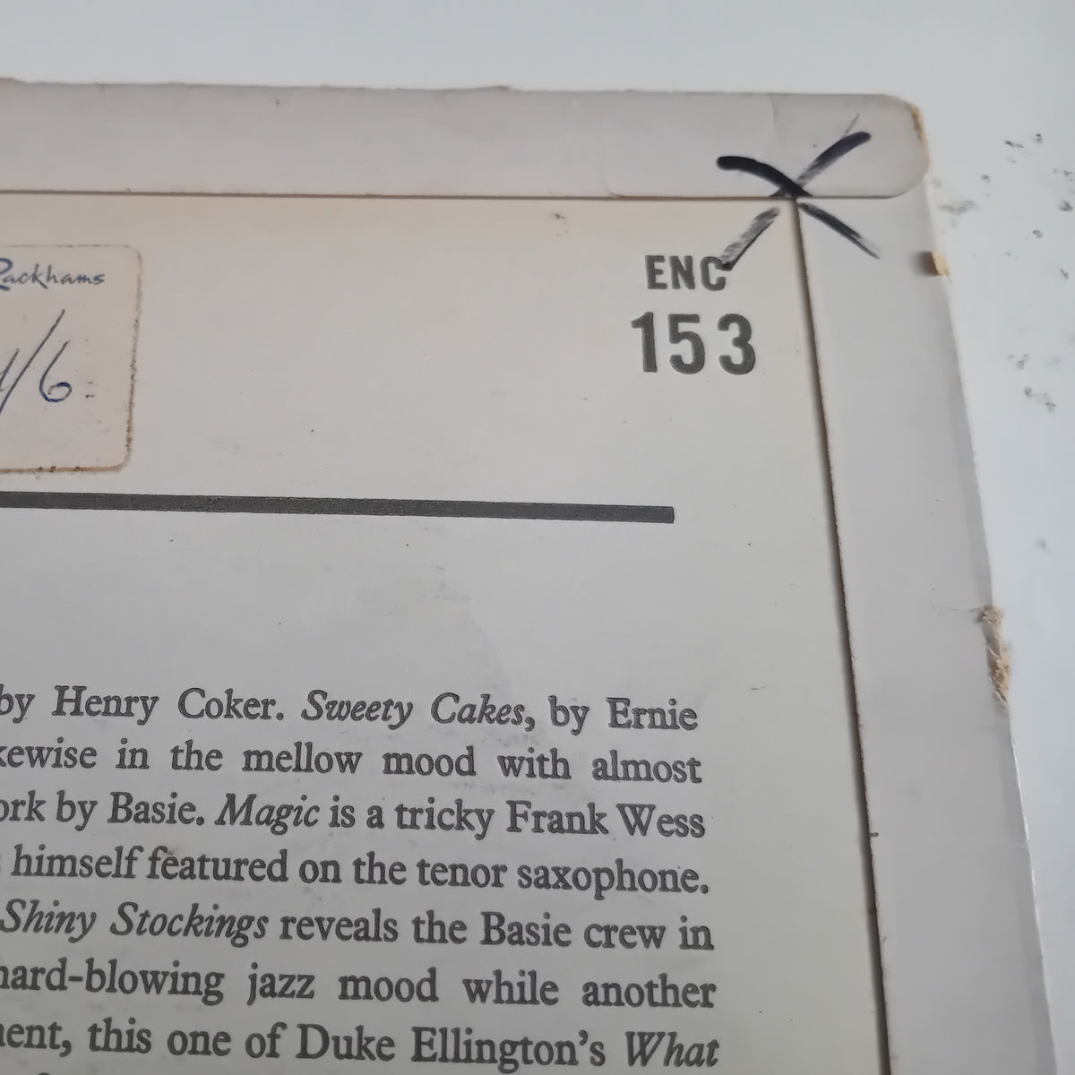 Close-up of the rear cover of an LP, showing printed text, a small handwritten note, and the printed code 'ENC 153' with a black mark crossing it.