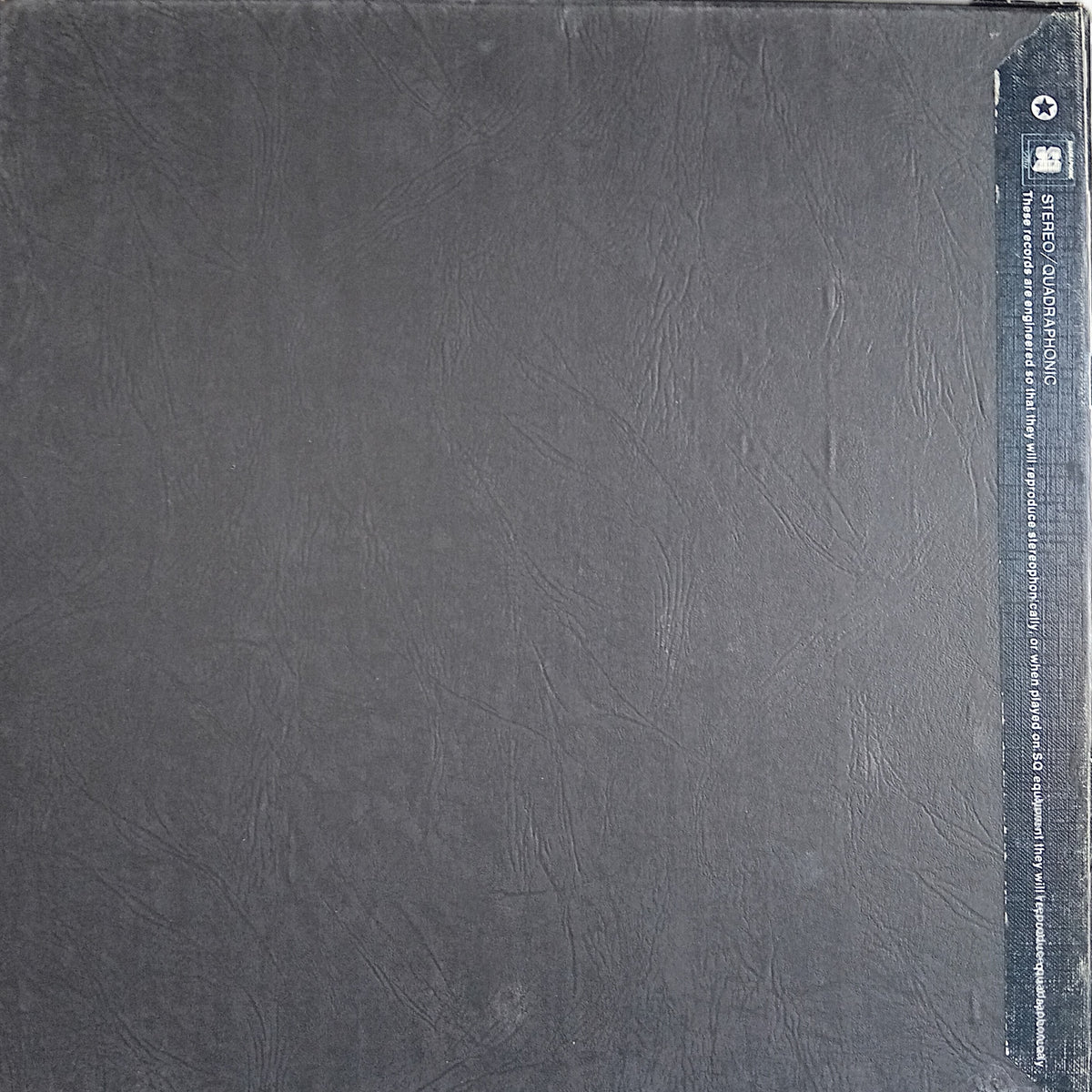 A square dark gray textured vinyl record sleeve or album cover, showing a black spine strip on the right side with small white text and a logo.