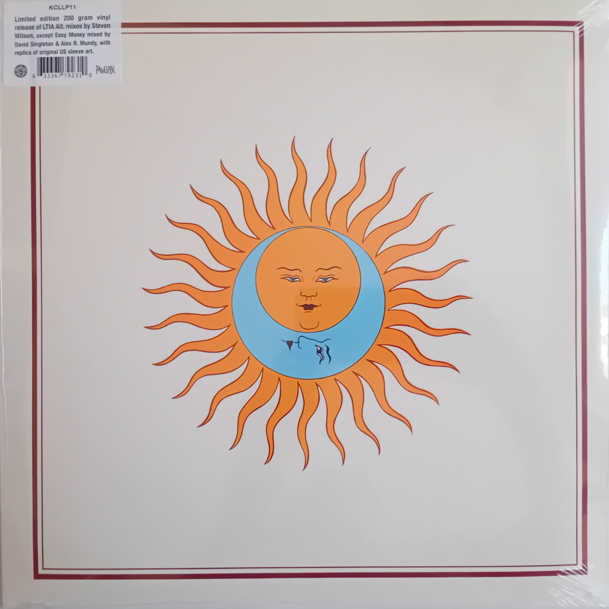Vinyl record sleeve for King Crimson's 'Larks' Tongues In Aspic' LP, featuring a stylized orange sun with a crescent moon face on a cream background with a thin red border.
