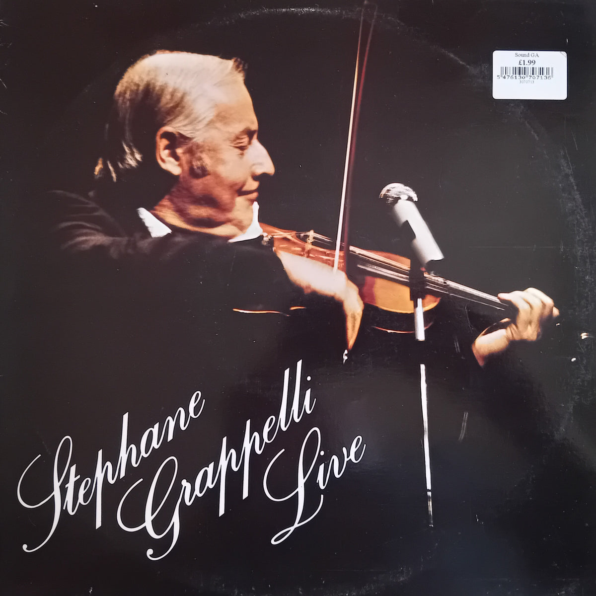 Vinyl record album cover for 'Stephane Grappelli Live' featuring a photograph of the violinist performing, with white script title text over a dark background.
