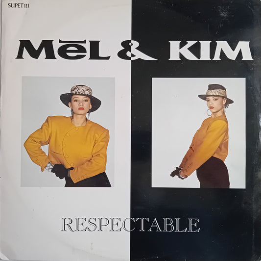 Vinyl record single cover for Mel & Kim's 'Respectable', featuring a split white and black background with two photos of the model wearing a mustard yellow jacket and black skirt.