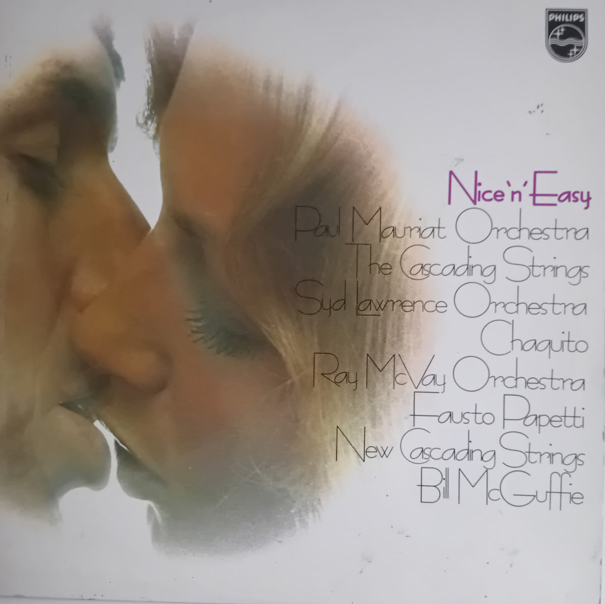 Vinyl record cover for 'Nice 'n Easy' including Paul Mauriat Orchestra, featuring a soft-focus artistic portrait of two faces on the left and a list of performing orchestras on the right, with a Philips 4Plus logo in the top right corner.