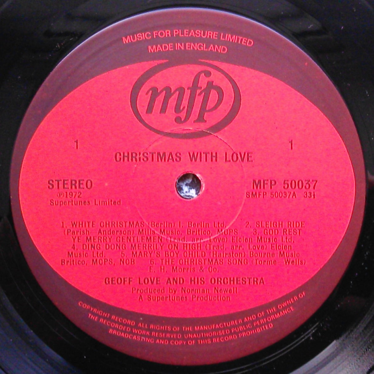 Vinyl record label with 'mfp' logo and text on a red background