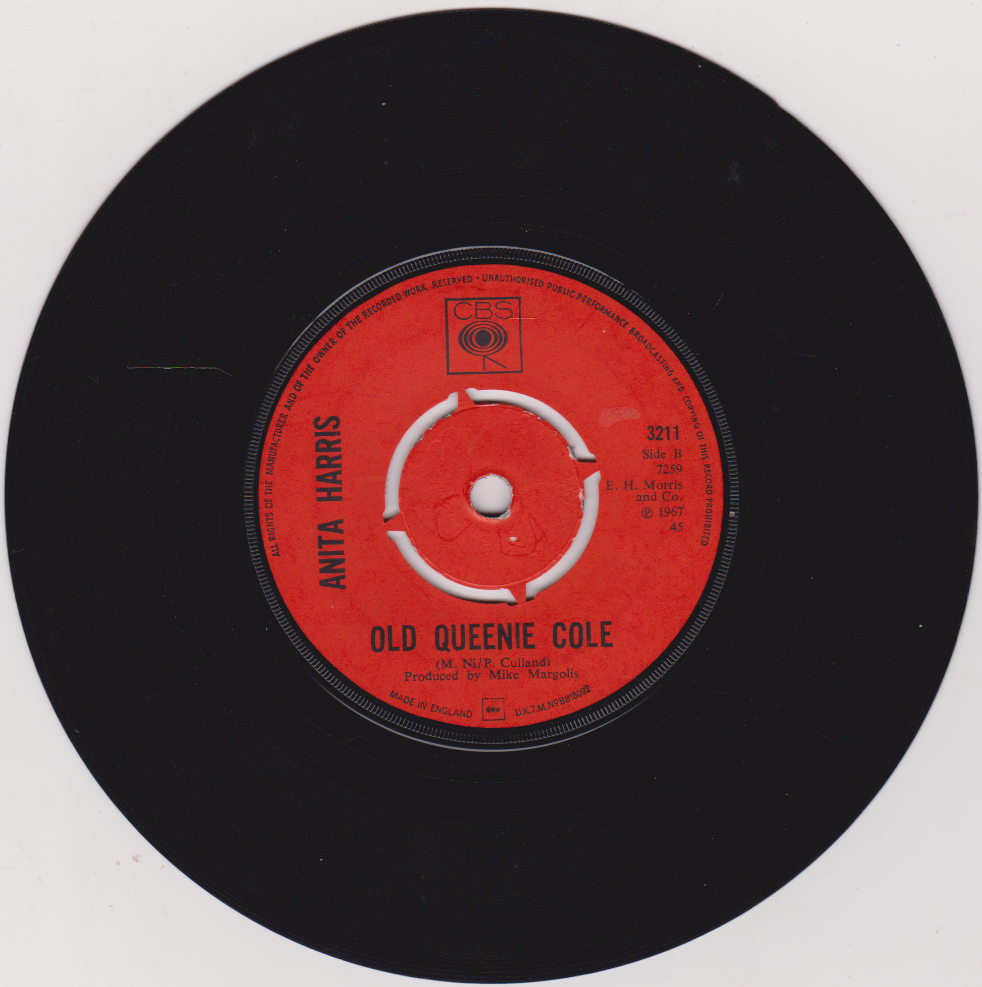 Vinyl record label with red center and black outer ring on a white background