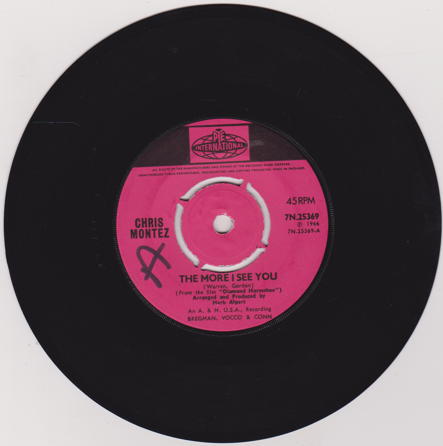 Vinyl record with pink label featuring 'Chris Montez' and song title on a white background