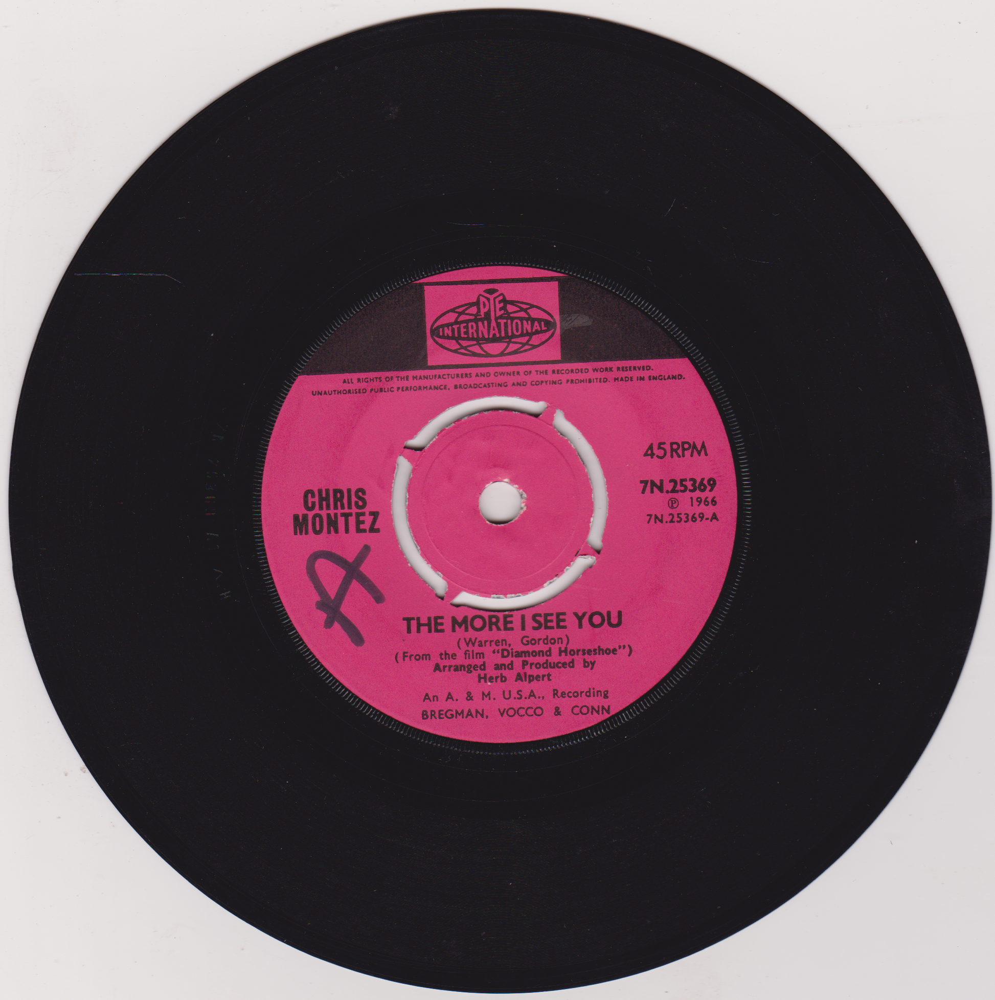 Vinyl record with pink label featuring 'Chris Montez' and song title on a white background