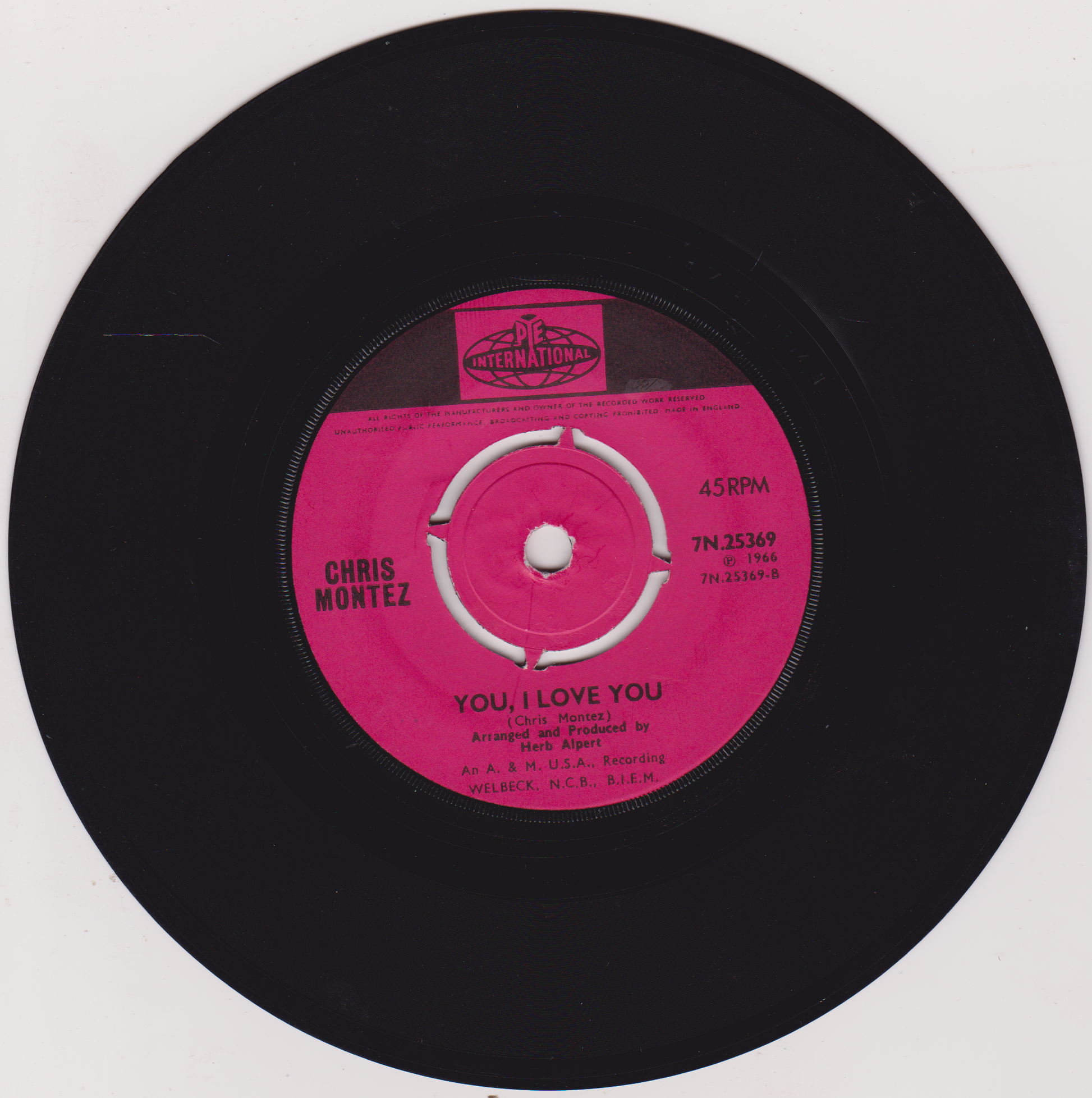 Vinyl record with a pink label featuring 'Chris Montez' and 'You Love Me' text.