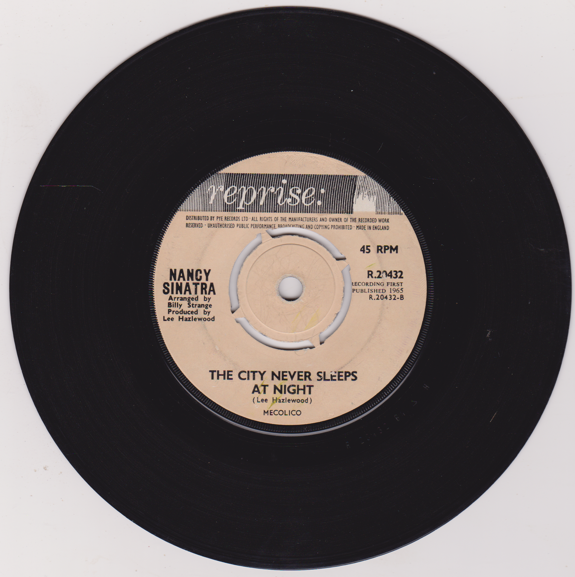Vinyl record with a beige label featuring Nancy Sinatra's name and song title on a white background