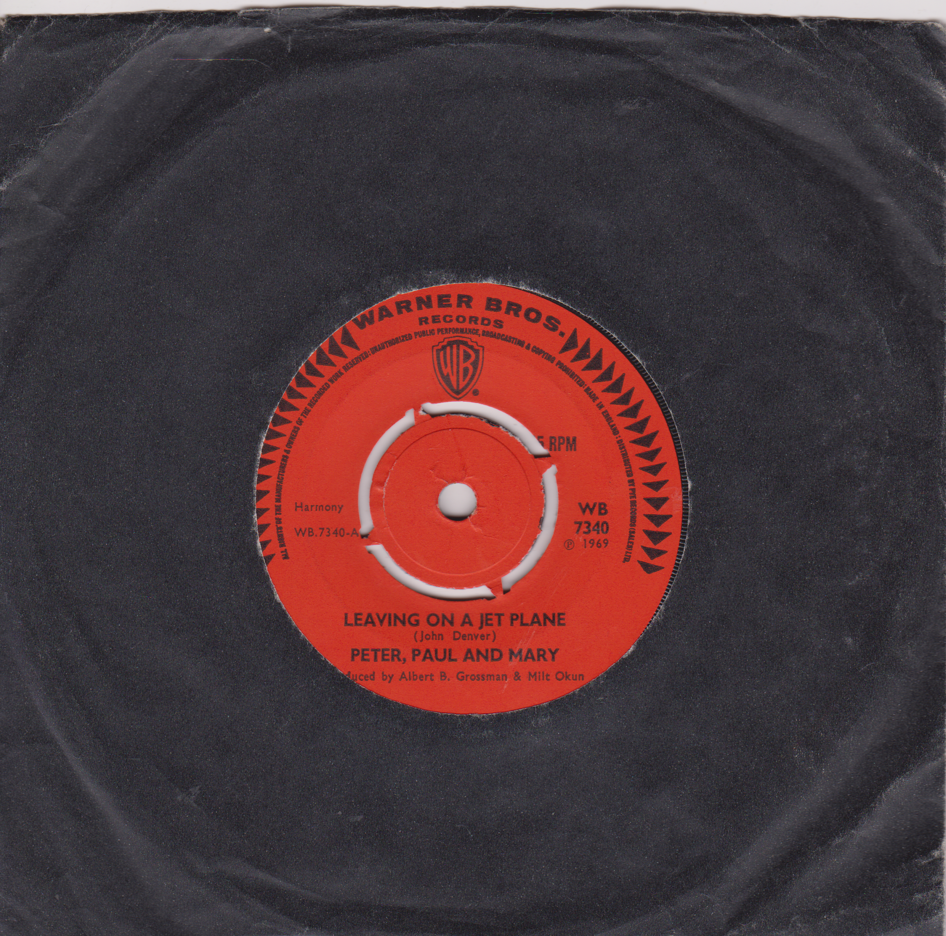 Vinyl record with a red label featuring Warner Bros. Records logo