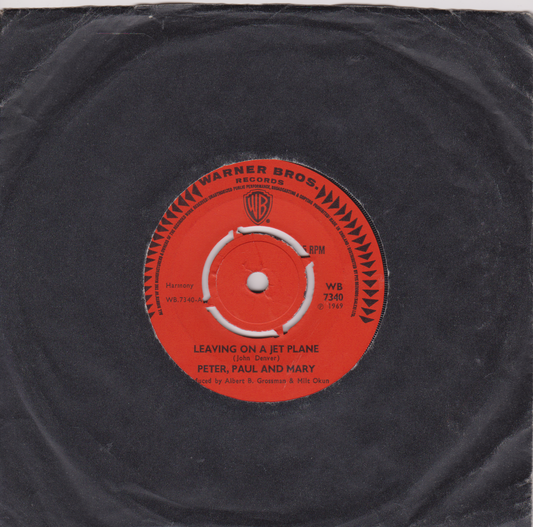 Vinyl record with a red label featuring Warner Bros. Records logo