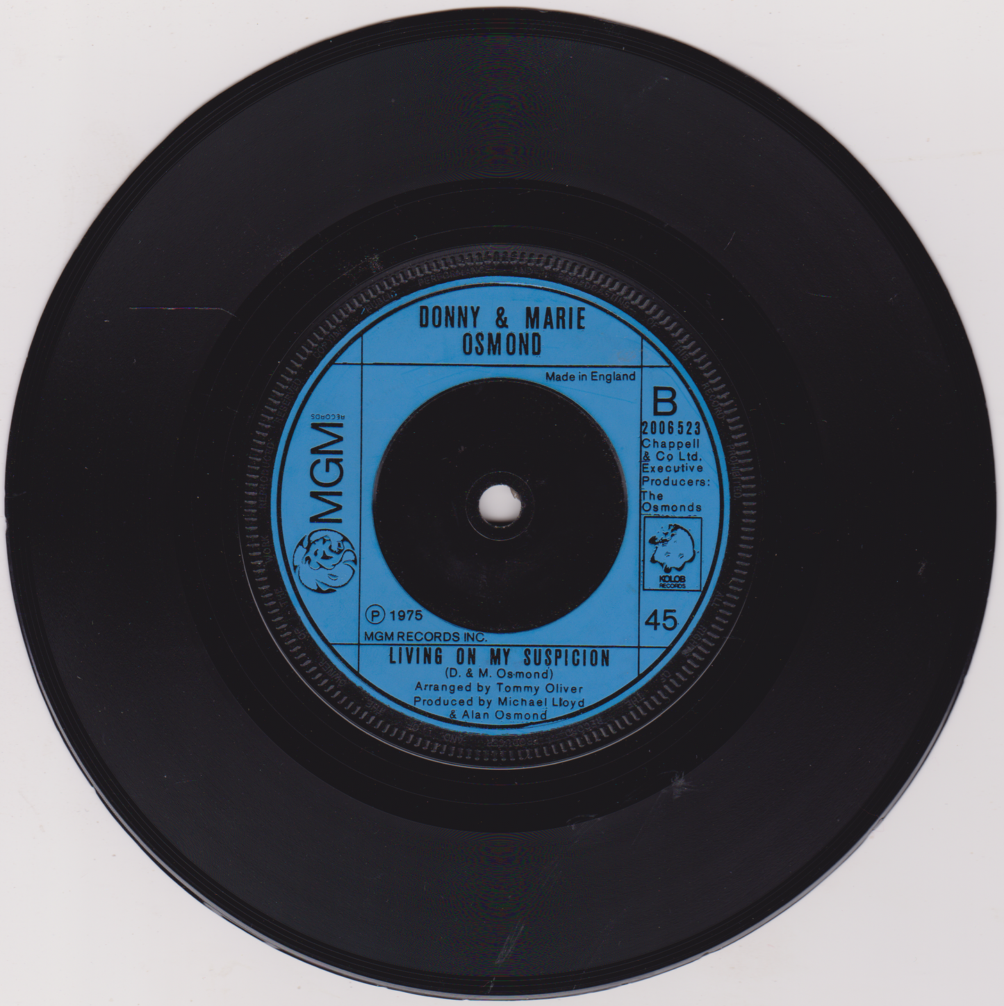 Vinyl record with blue label featuring 'Donny & Marie Osmond' on a white background