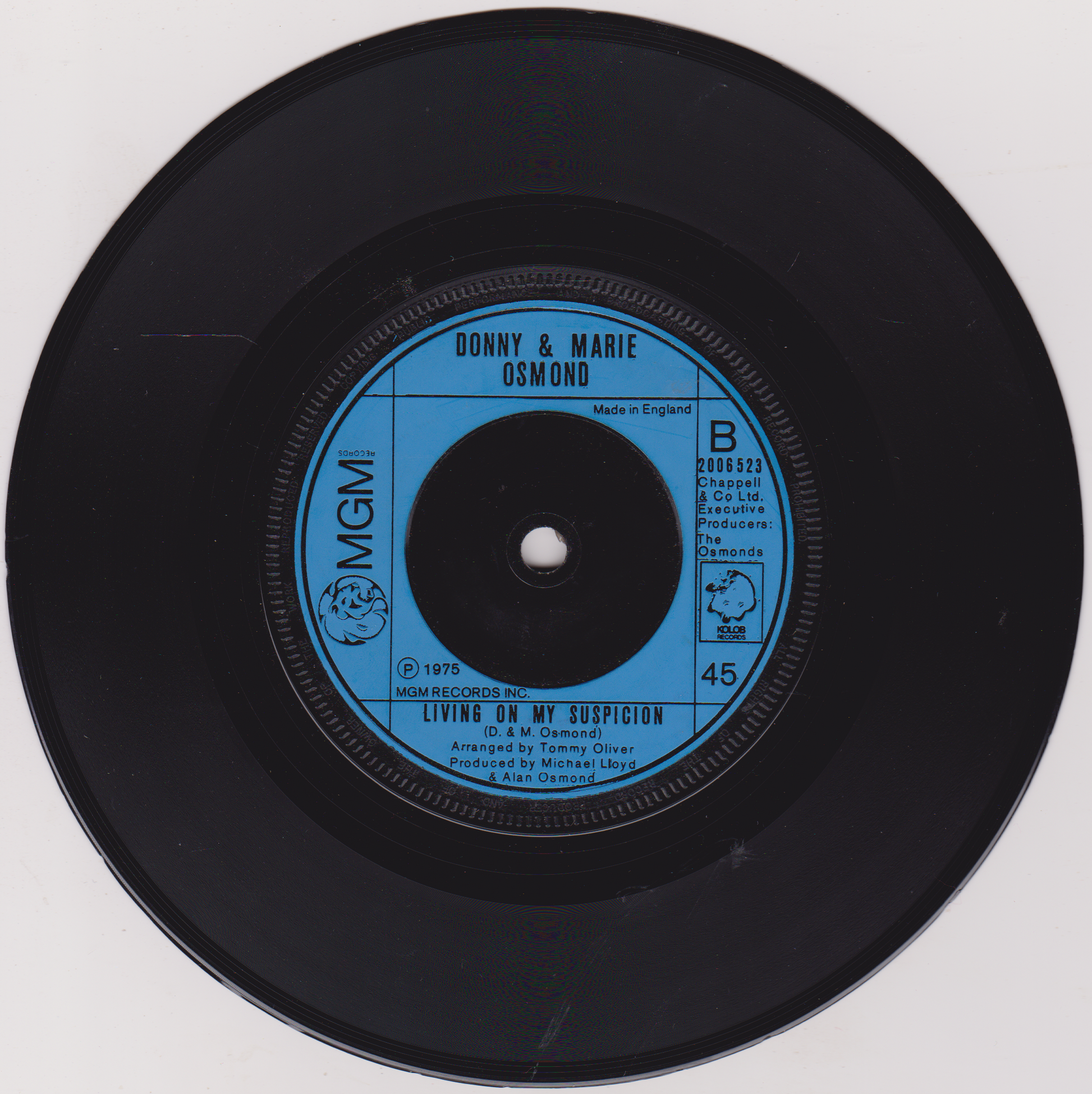 Vinyl record with blue label featuring 'Donny & Marie Osmond' on a white background