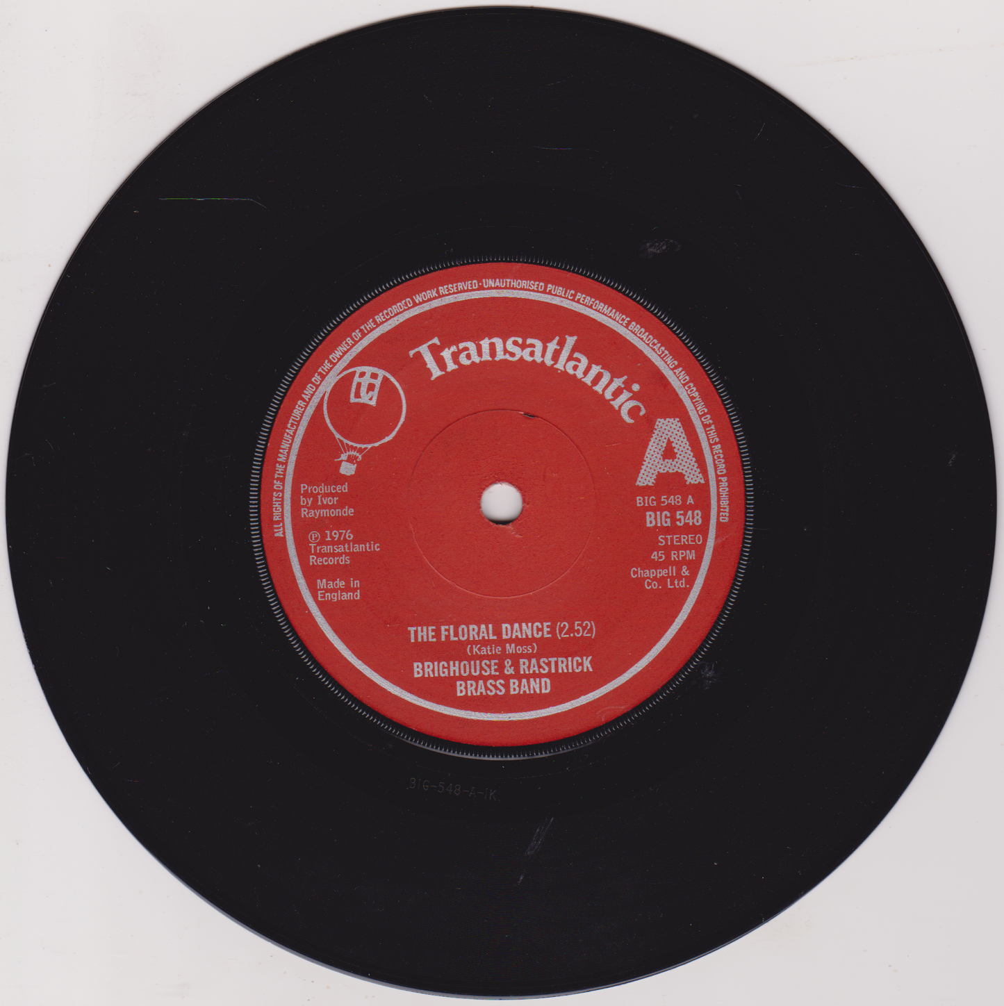 Vinyl record with red label on a white background