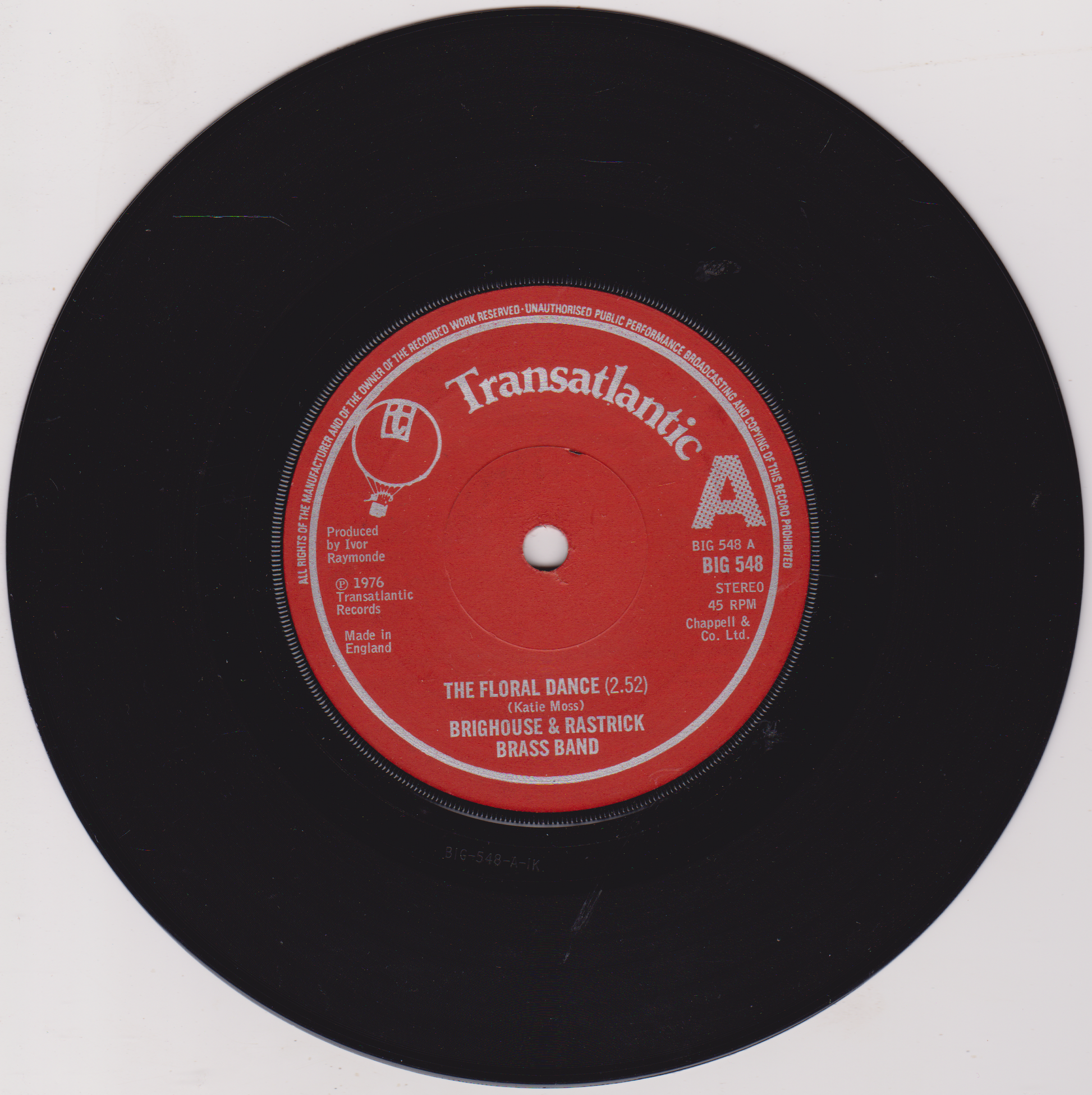 Vinyl record with red label on a white background