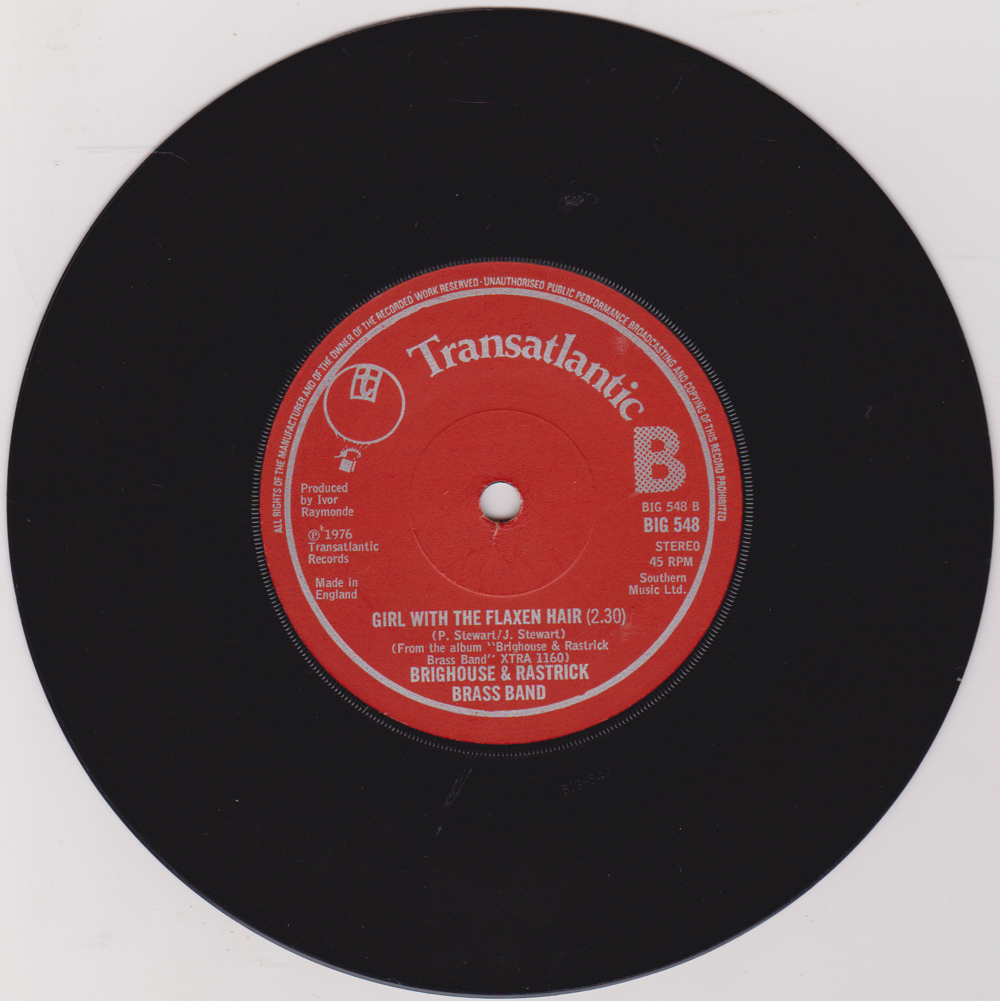 Vinyl record with a red label on a white background