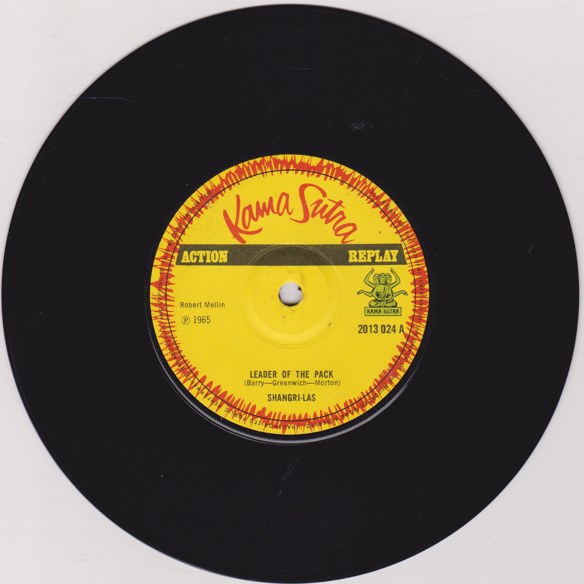 Vinyl record with a yellow label featuring 'Kama Sutra' and 'Action Replay' text on a white background.