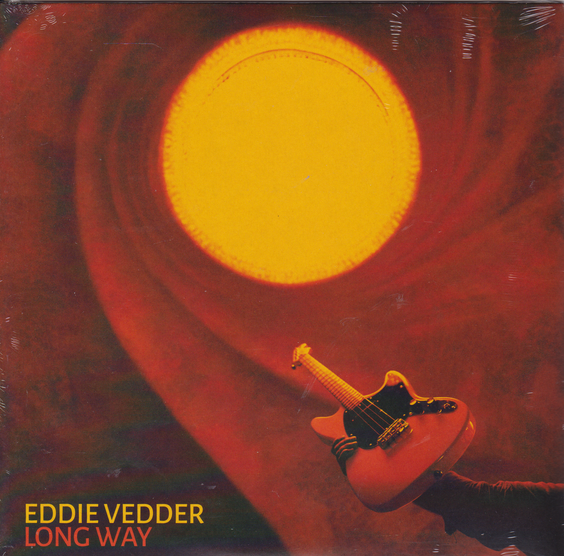 Single cover with a guitar and a large yellow circle on a red background, featuring Eddie Vedder's name.