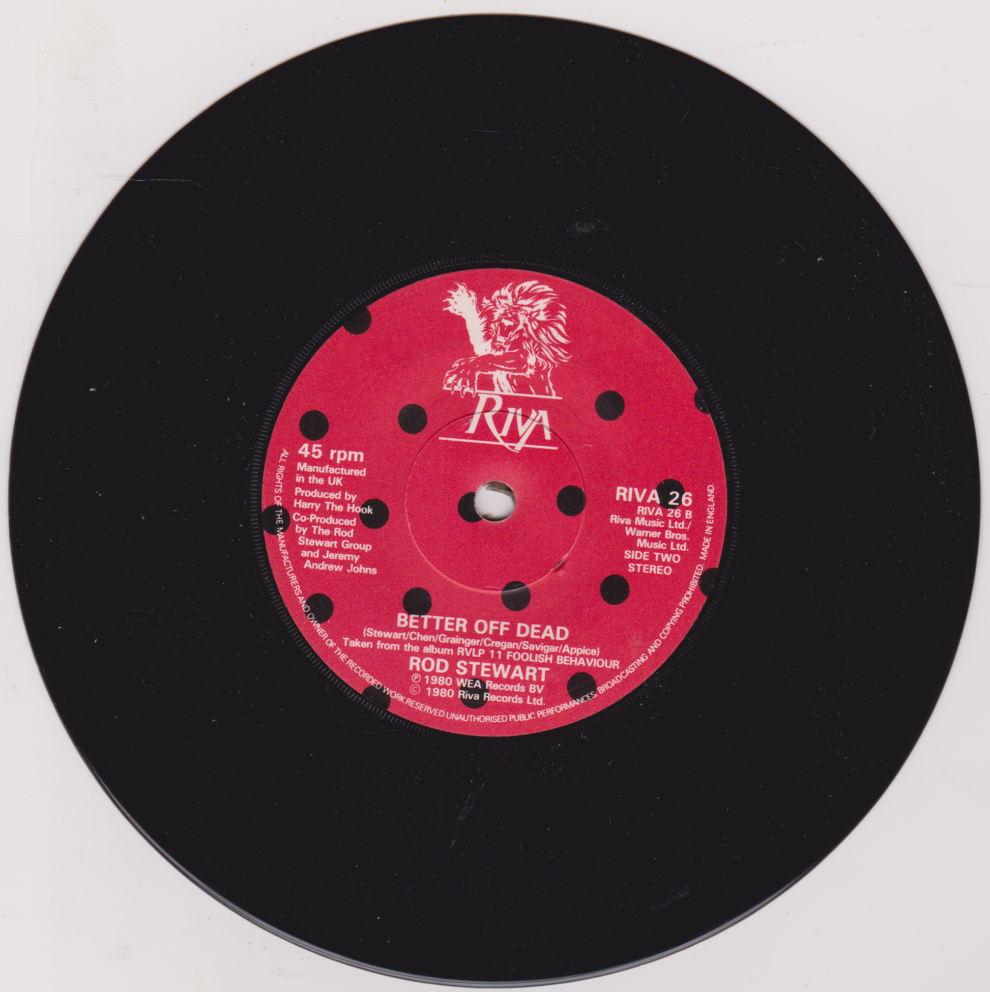 Vinyl record with a red label featuring text and a logo on a white background