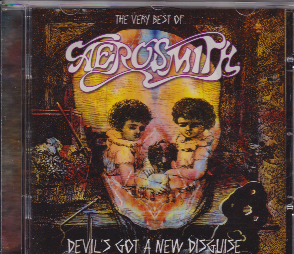 Aerosmith 'The Very Best of Aerosmith' CD album cover, showing two children inside a large skull with the album title 'Devil's Got a New Disguise' at the bottom.