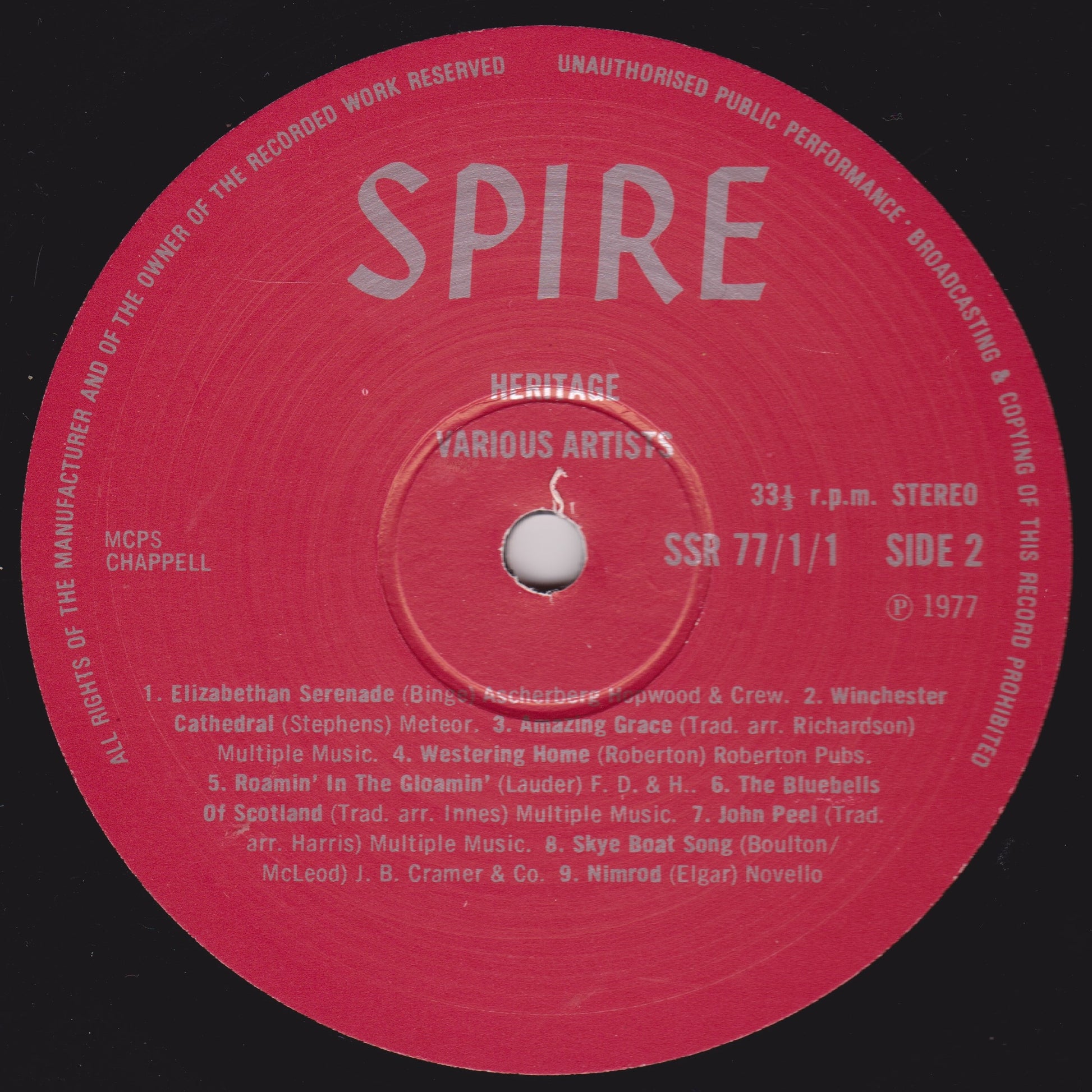 Red vinyl record label with 'SPIRE' branding and text on a black background