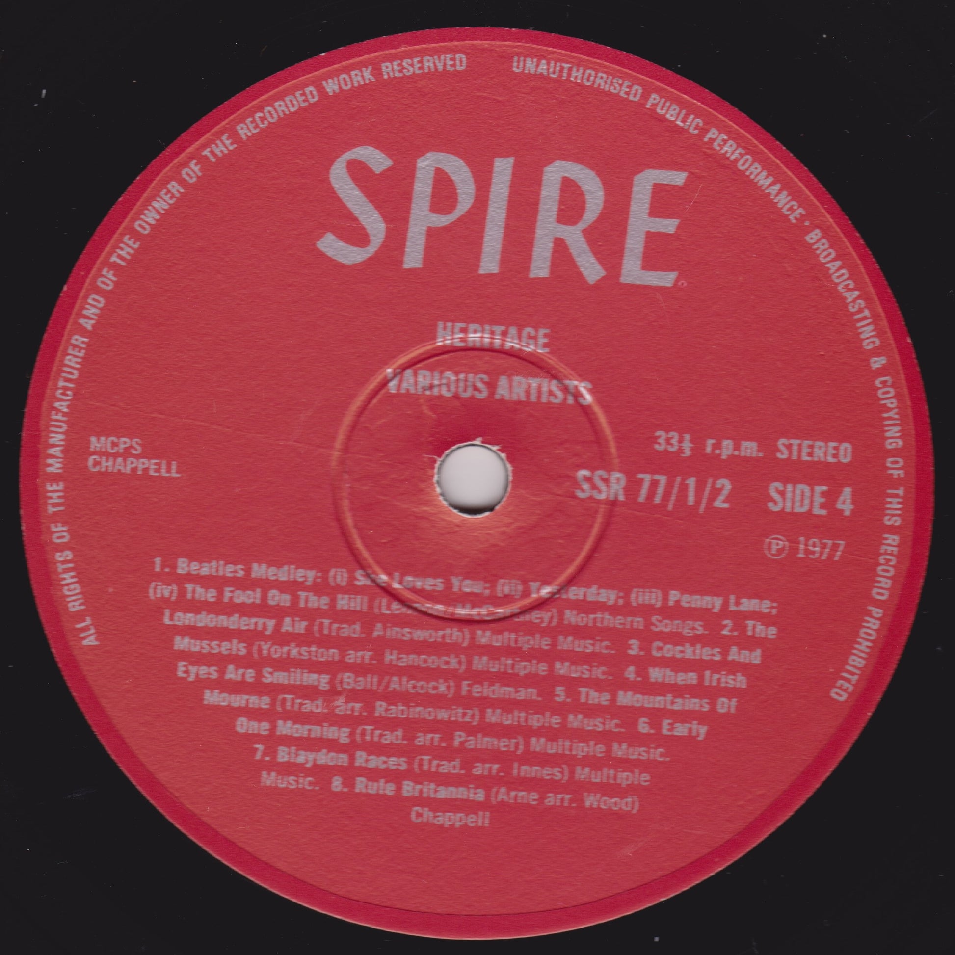 Red vinyl record label with 'SPIRE' branding and text on a black background