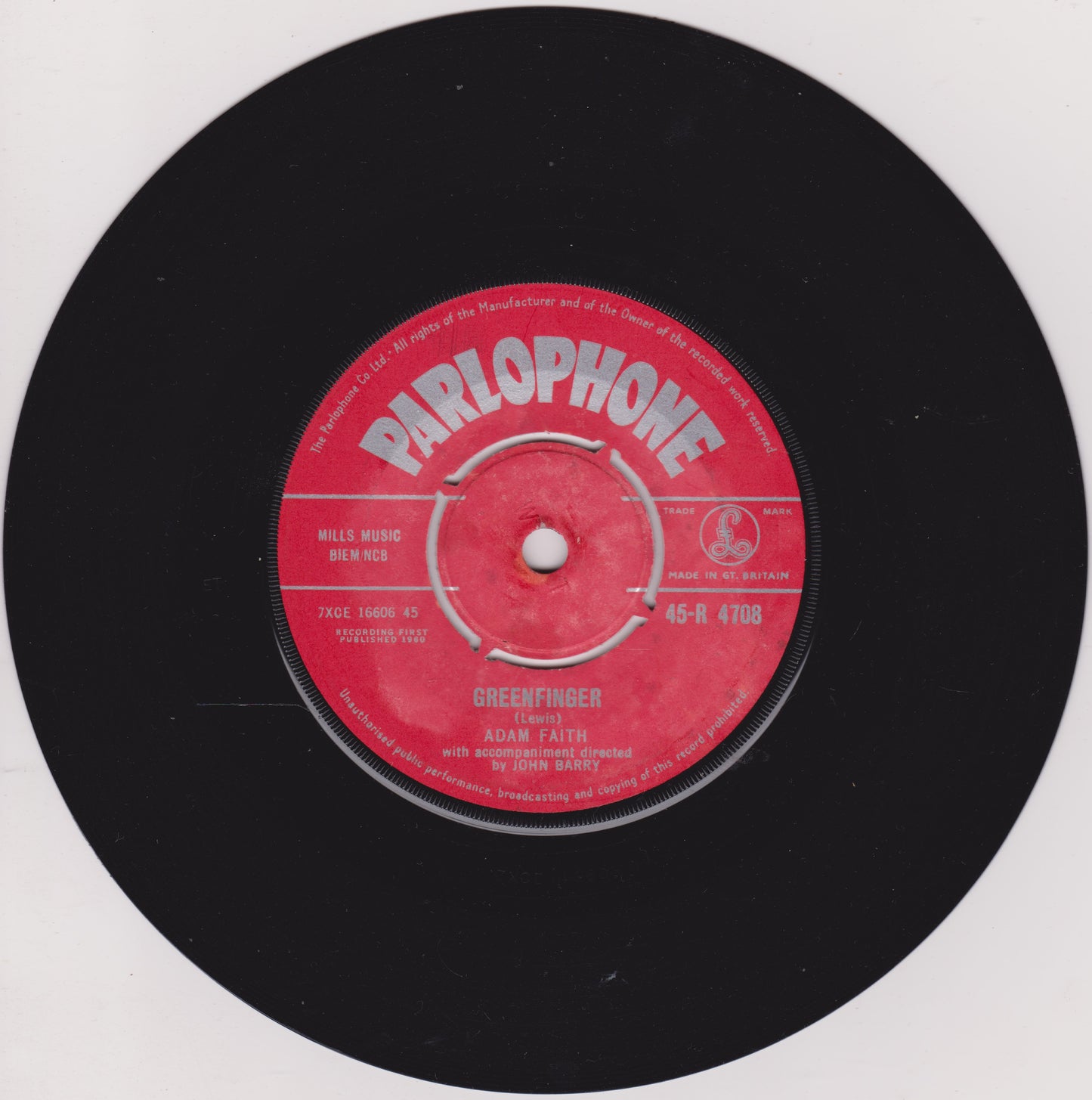 Black vinyl record with a red Parlophone label on a white background