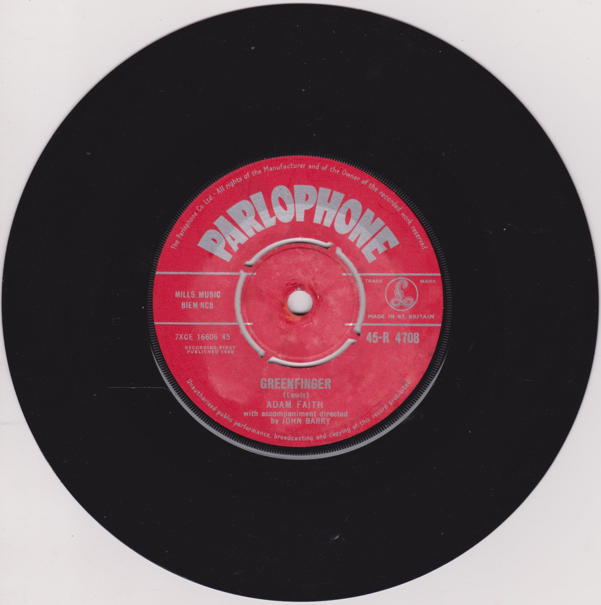 Black vinyl record with a red Parlophone label on a white background