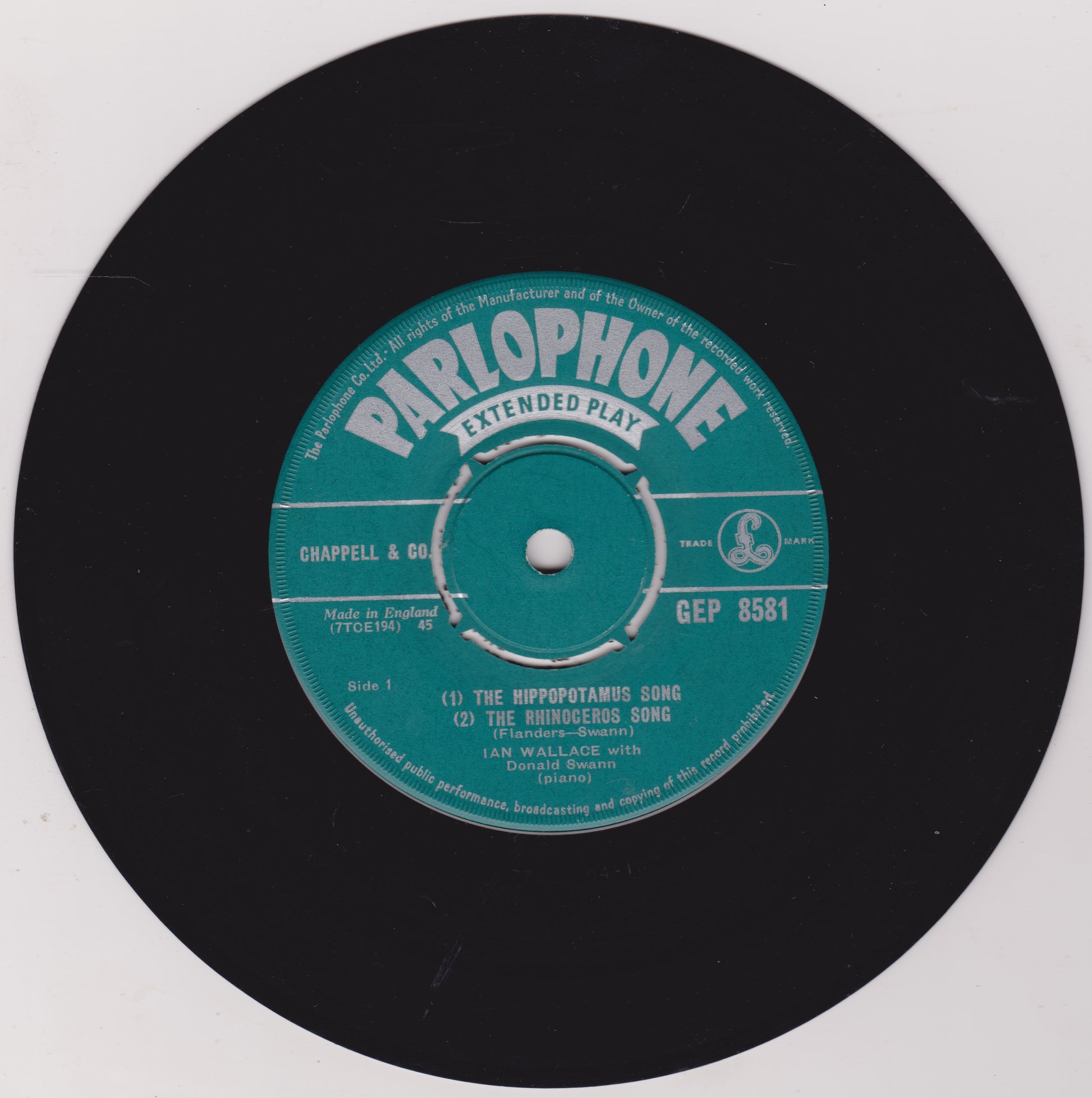 Parlophone extended play record label on a black vinyl record with a white background
