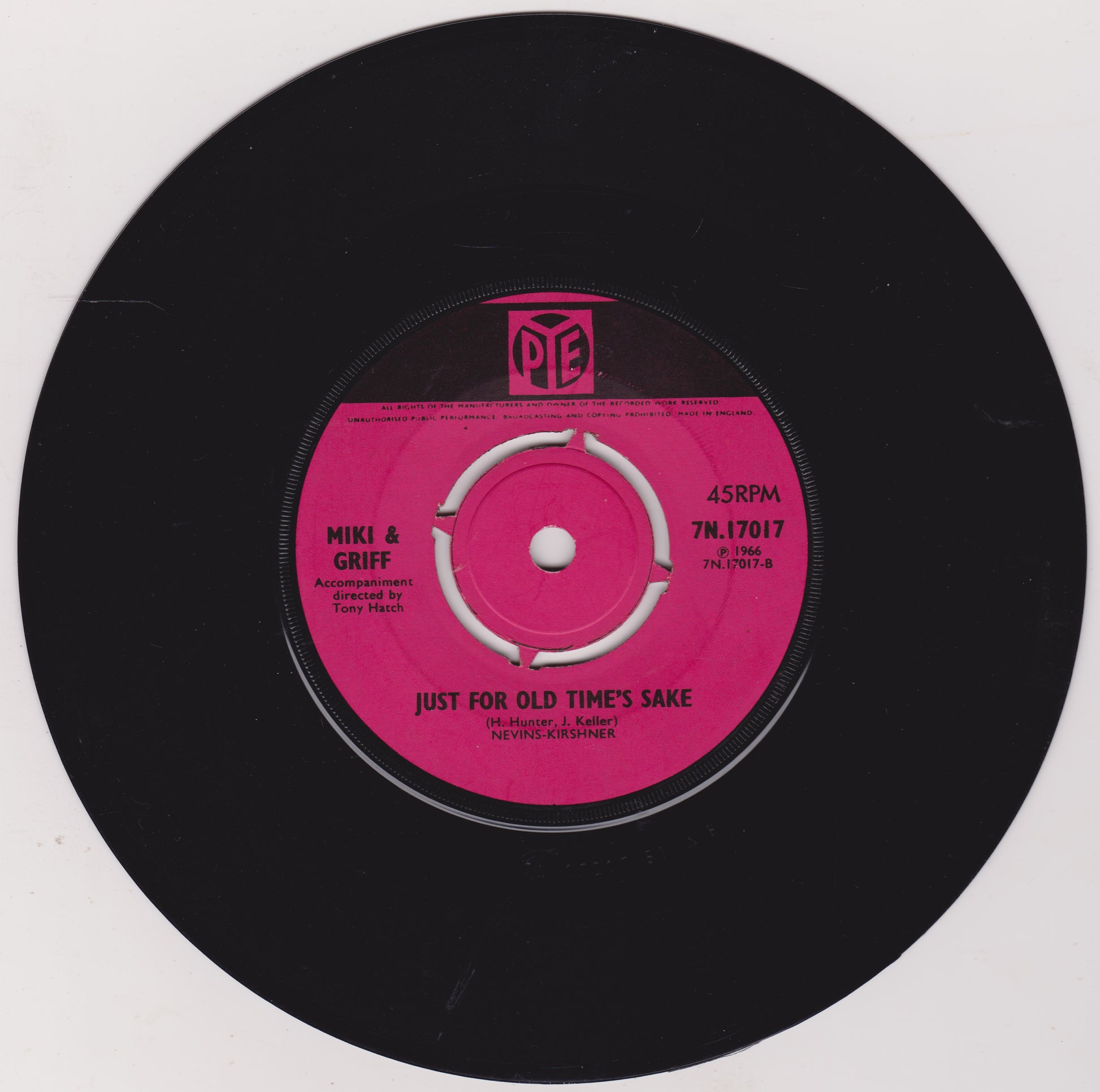 Vinyl record with a pink label on a black background