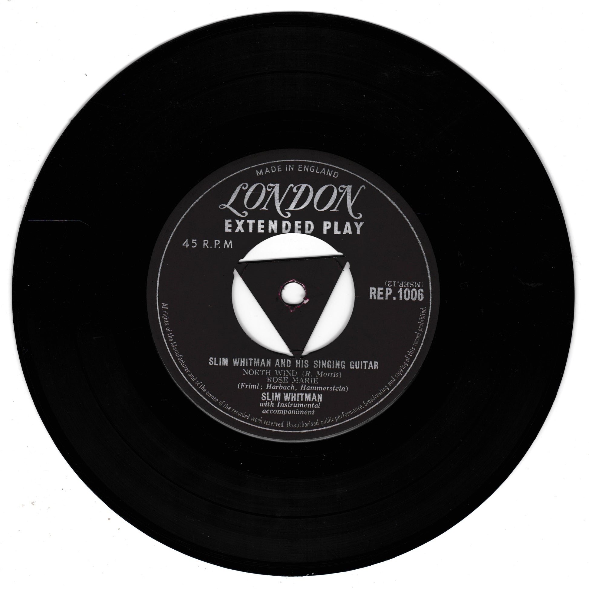 A black 45 RPM vinyl record with a white and black centre label reading 'London Extended Play' and 'Slim Whitman and his singing guitar', photographed on a plain white background.