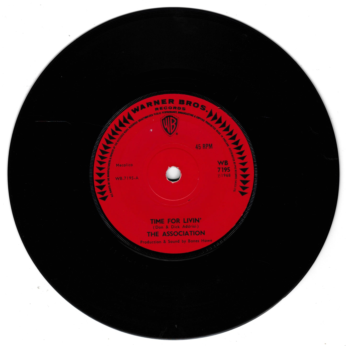 A black vinyl record with a bright red centre label. The label reads 'Warner Bros.