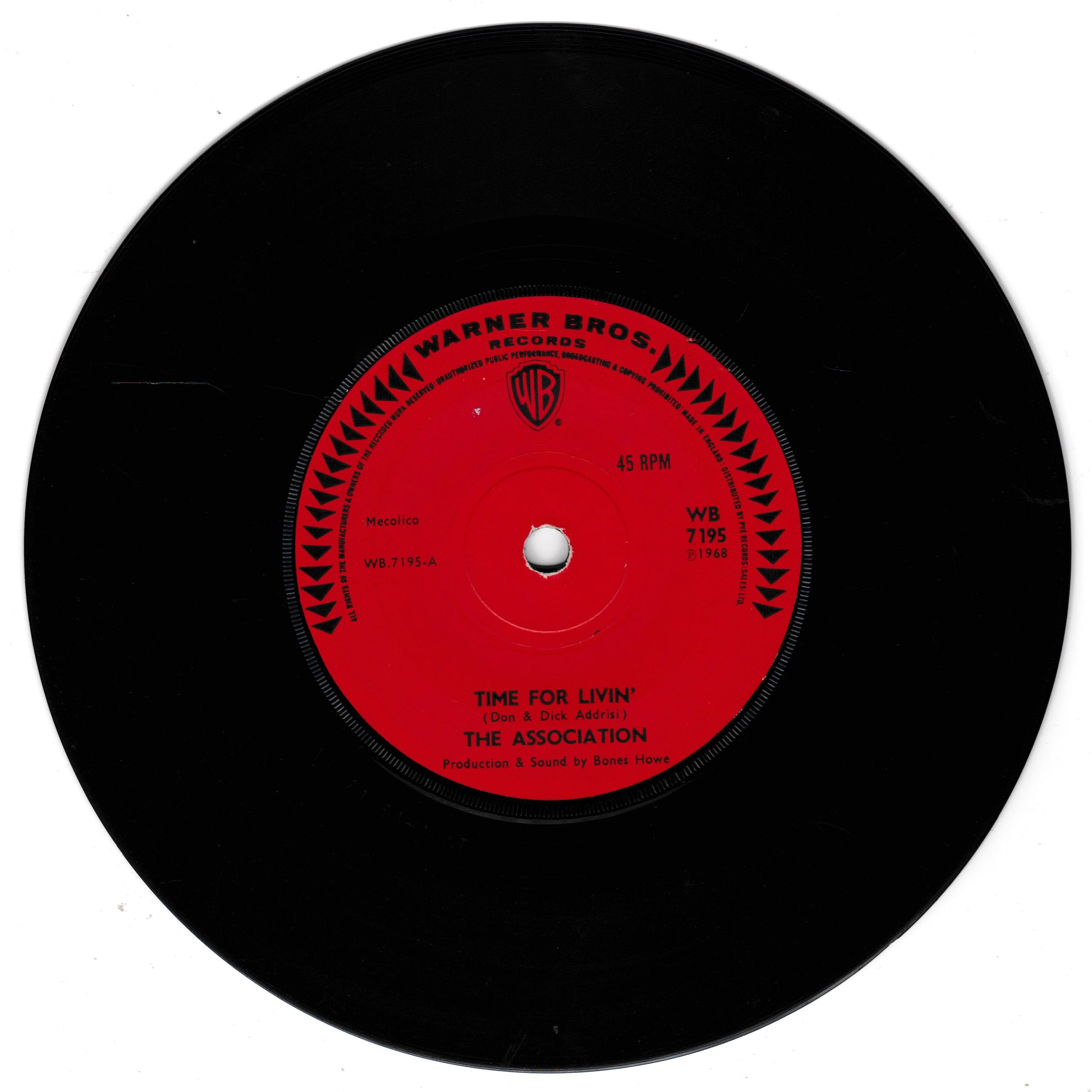 A black vinyl record with a bright red centre label. The label reads 'Warner Bros.