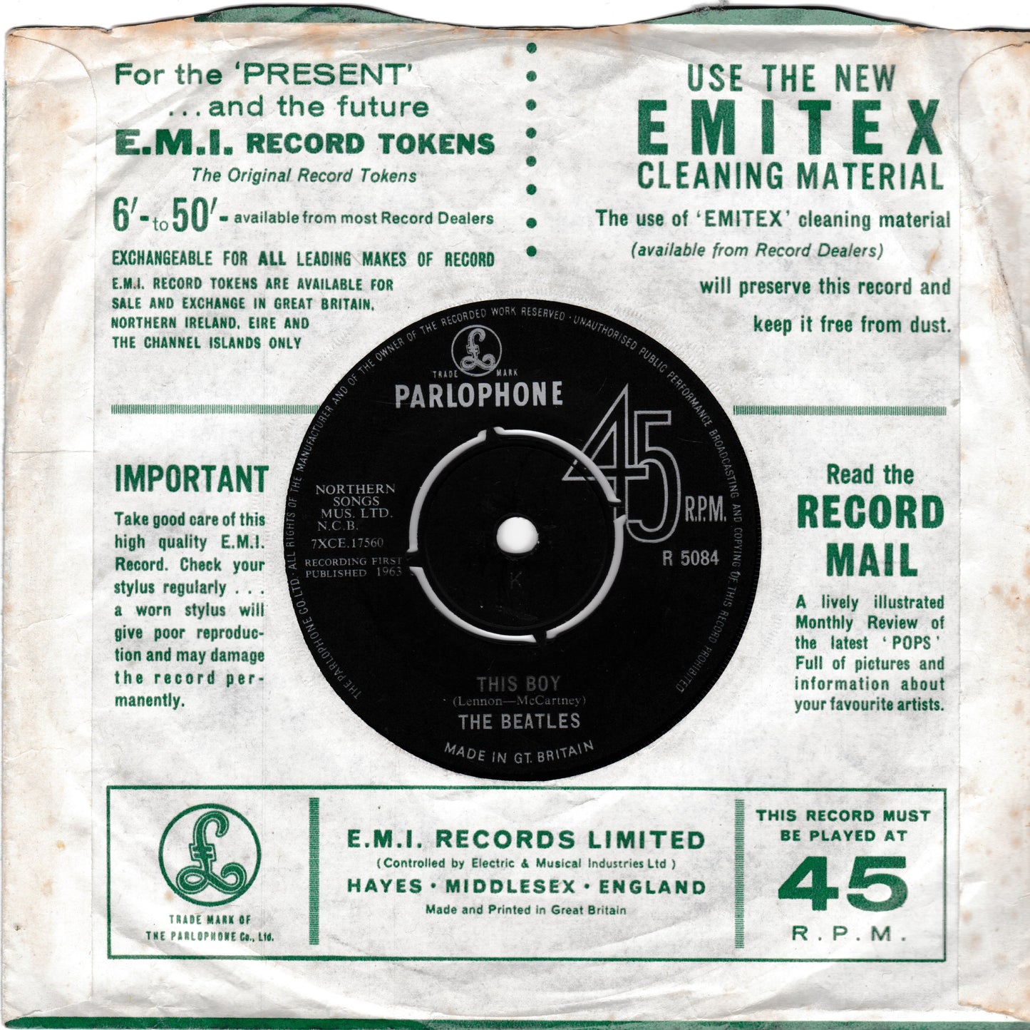 Vintage EMI Records record sleeve insert for The Beatles' 'This Boy' 45 RPM vinyl record, featuring a black record label in the centre with white text, surrounded by green and black printed promotional text on an off-white background.