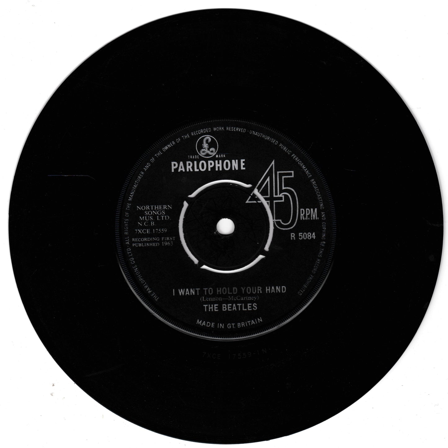 A black 45 RPM vinyl record with a white Parlophone label, featuring The Beatles' 'I Want To Hold Your Hand'.