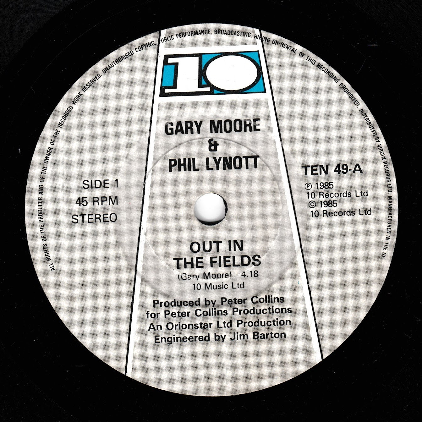 A close-up of a vinyl record label for Gary Moore & Phil Lynott's 'Out in the Fields', showing the 10 Records logo and track details on a black record surface.