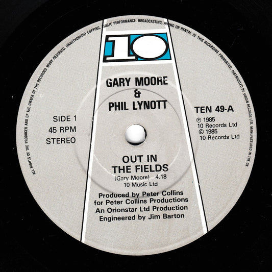 A close-up of a vinyl record label for Gary Moore & Phil Lynott's 'Out in the Fields', showing the 10 Records logo and track details on a black record surface.