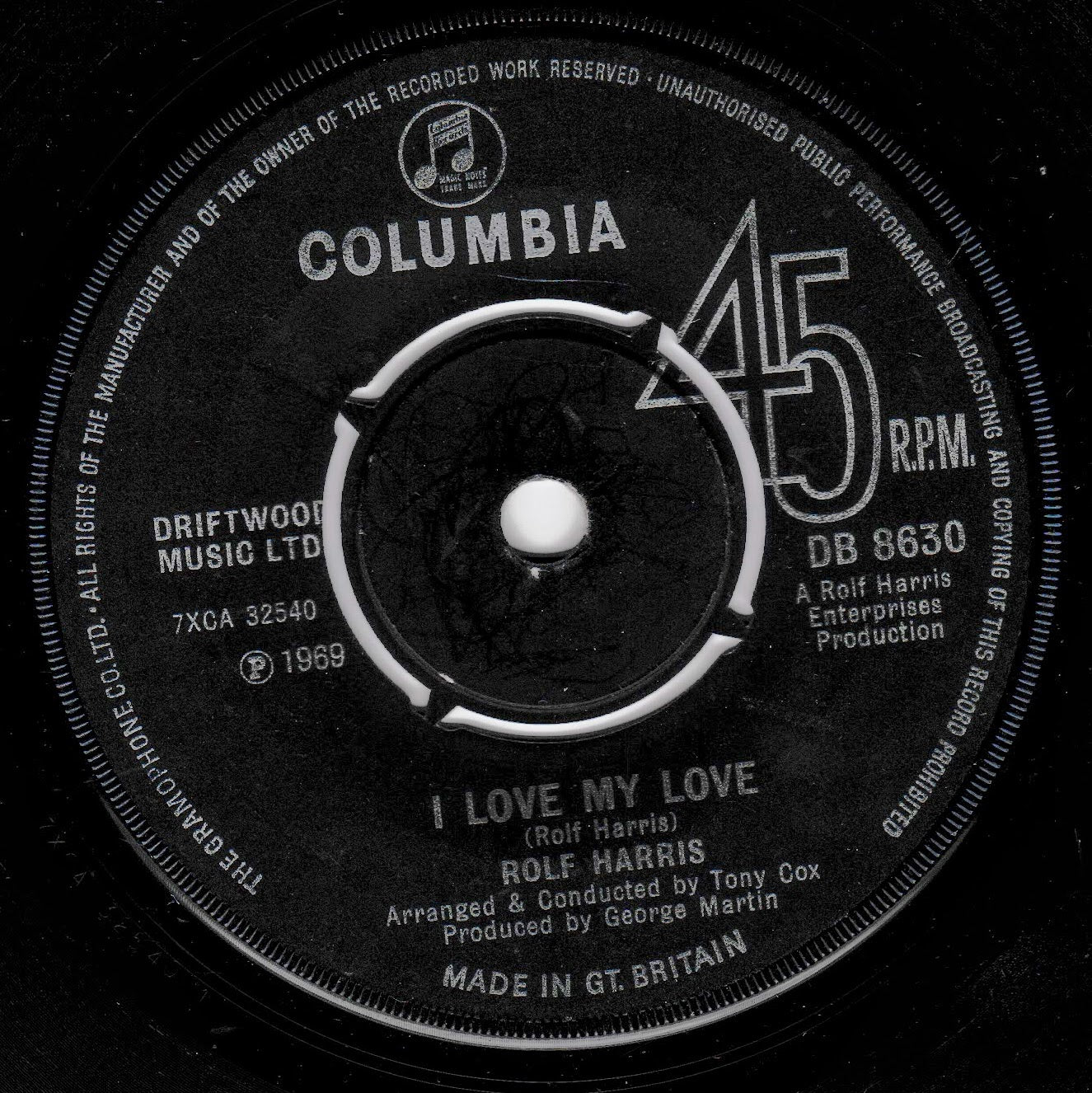 A close-up of a vintage black vinyl record label for Rolf Harris's 'I Love My Love' on Columbia Records, showing 45 RPM and track details in white text.