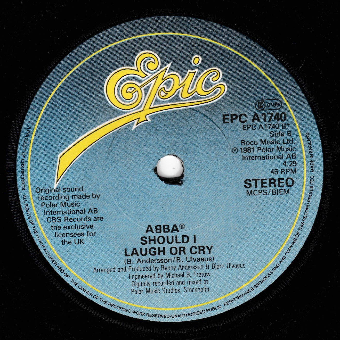 A close-up of a vintage record label from the brand Epic Records, featuring the song title 'Should I Laugh or Cry' by ABBA. The label is dark blue with a textured pattern, featuring yellow and white text and graphics.