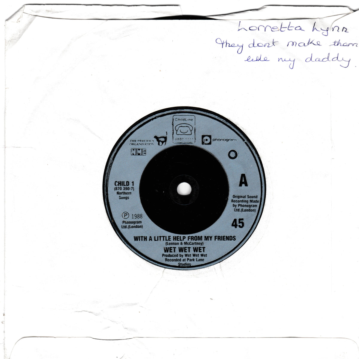 A vintage 45 single record sleeve for Wet Wet's 'With a Little Help from My Friends' on Columbia Records, featuring a silver centre label on a white paper sleeve with handwritten text in the upper right.
