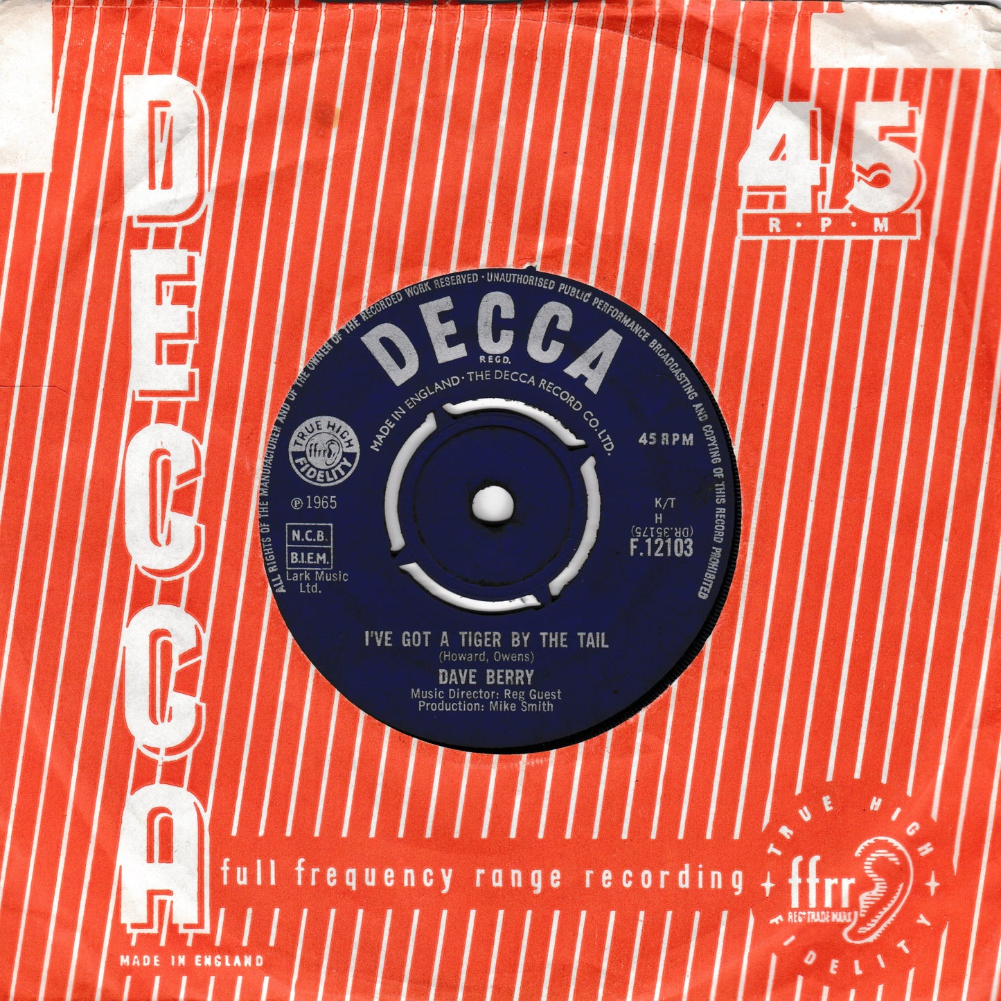 A vintage Decca 45 RPM vinyl record sleeve for Dave Berry's 'I've Got A Tiger By The Tail'. The sleeve features a bold red and white striped background with vertical 'DECCA' branding, and the central blue record label is clearly visible.