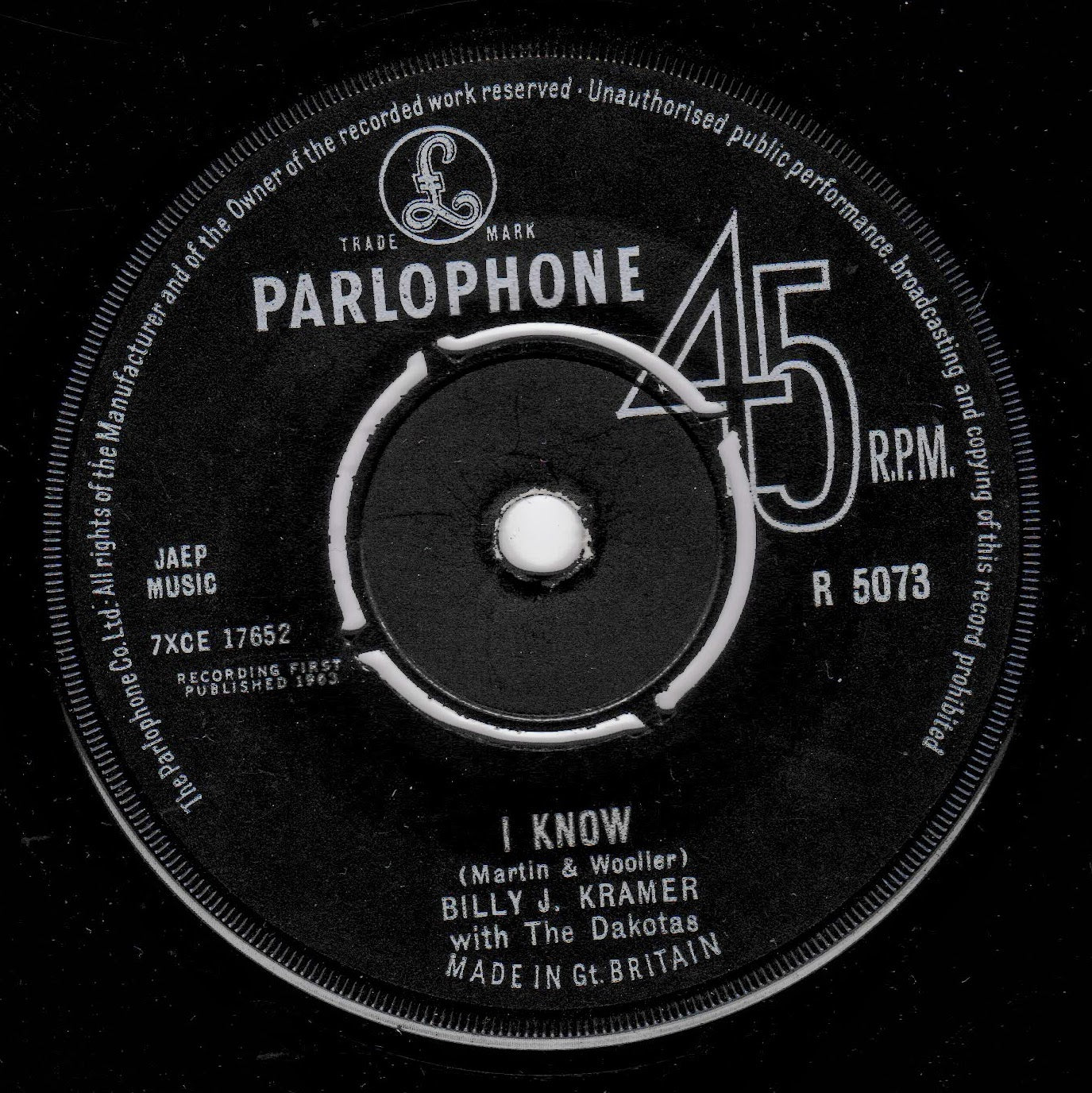 A black vinyl record label with white text reading PARLOPHONE, 45 RPM, and the song title I KNOW by Billy J. Kramer with The Dakotas.